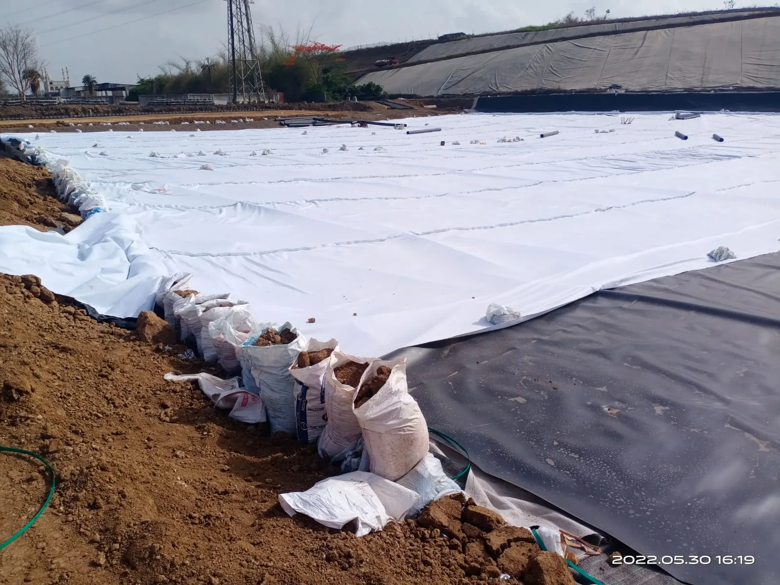 CONSTRUCTION OF BASE AND REINFORCED EARTHEN WALL FOR HAZARDOUS SOLID WASTE DISPOSAL CELLS AT CSWP SITE AT VAPI, GUJARAT